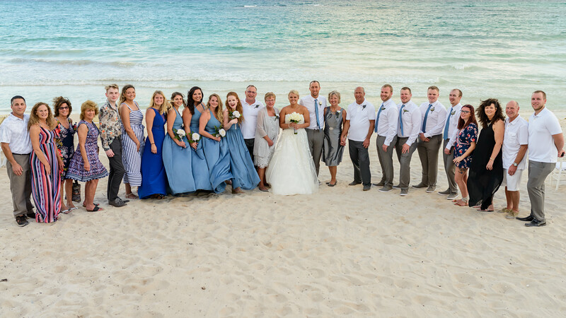 a group of people posing for a photo on a beach