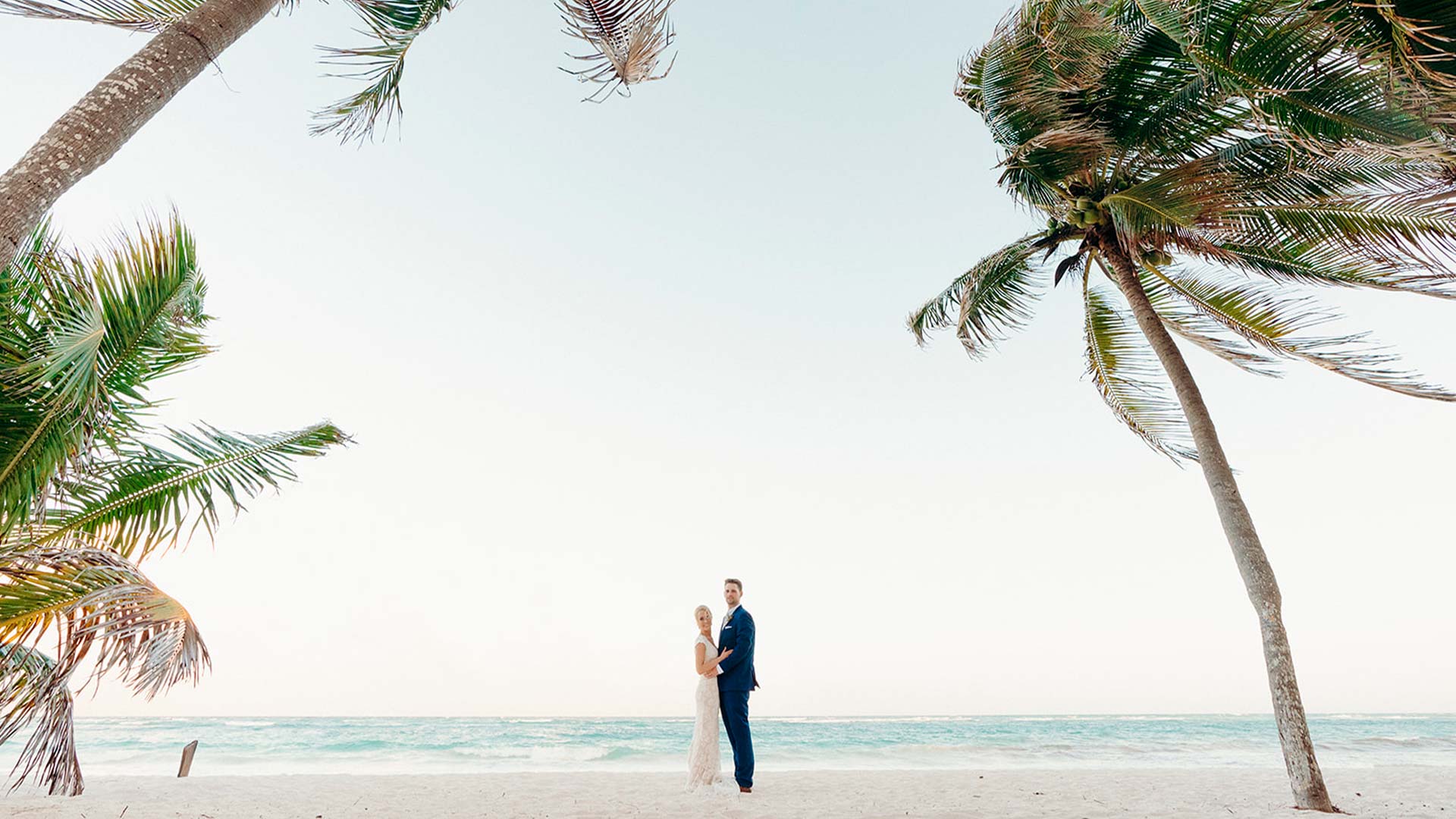 a man and woman standing on a beach