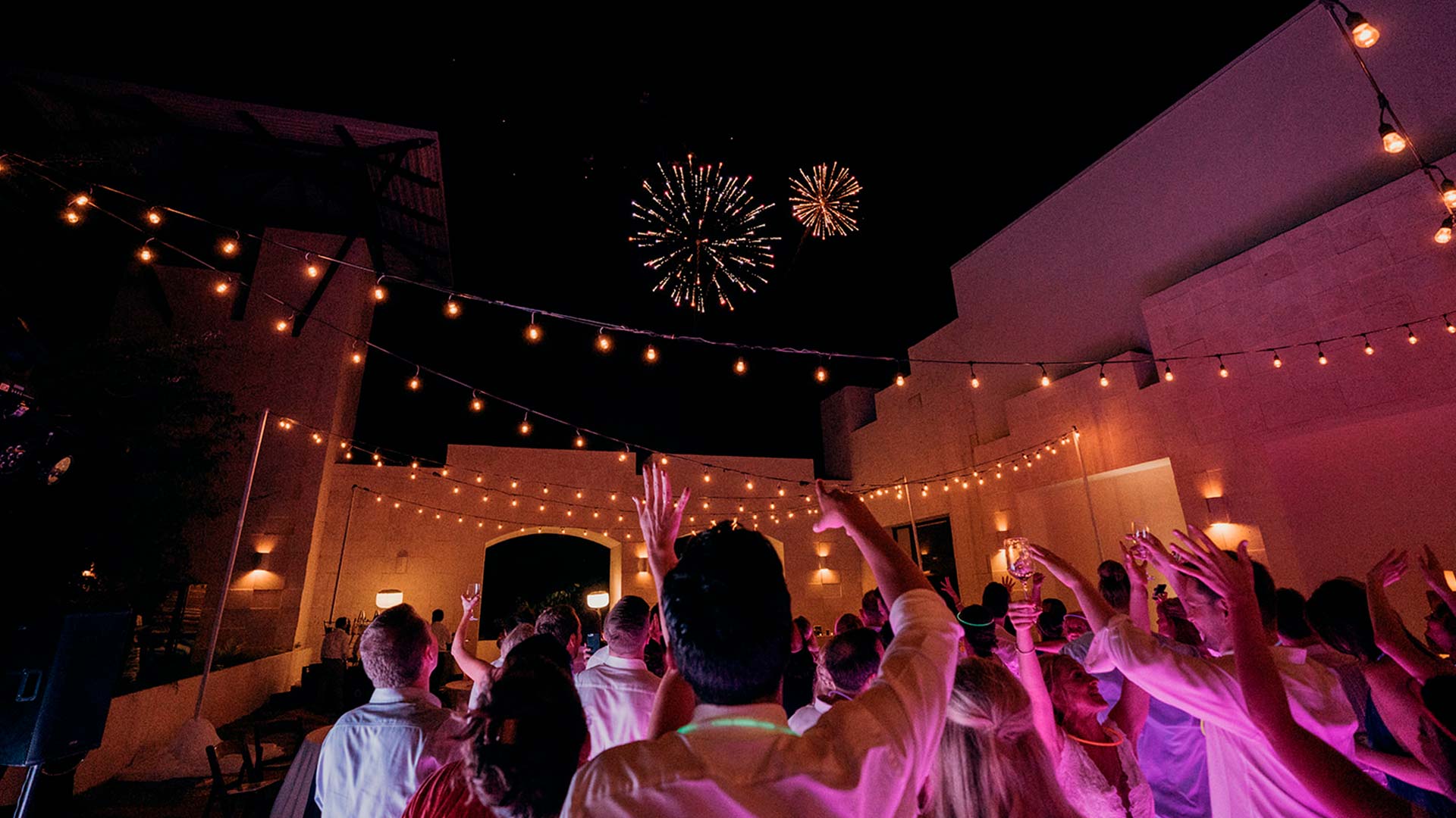 a group of people with their hands up in the air