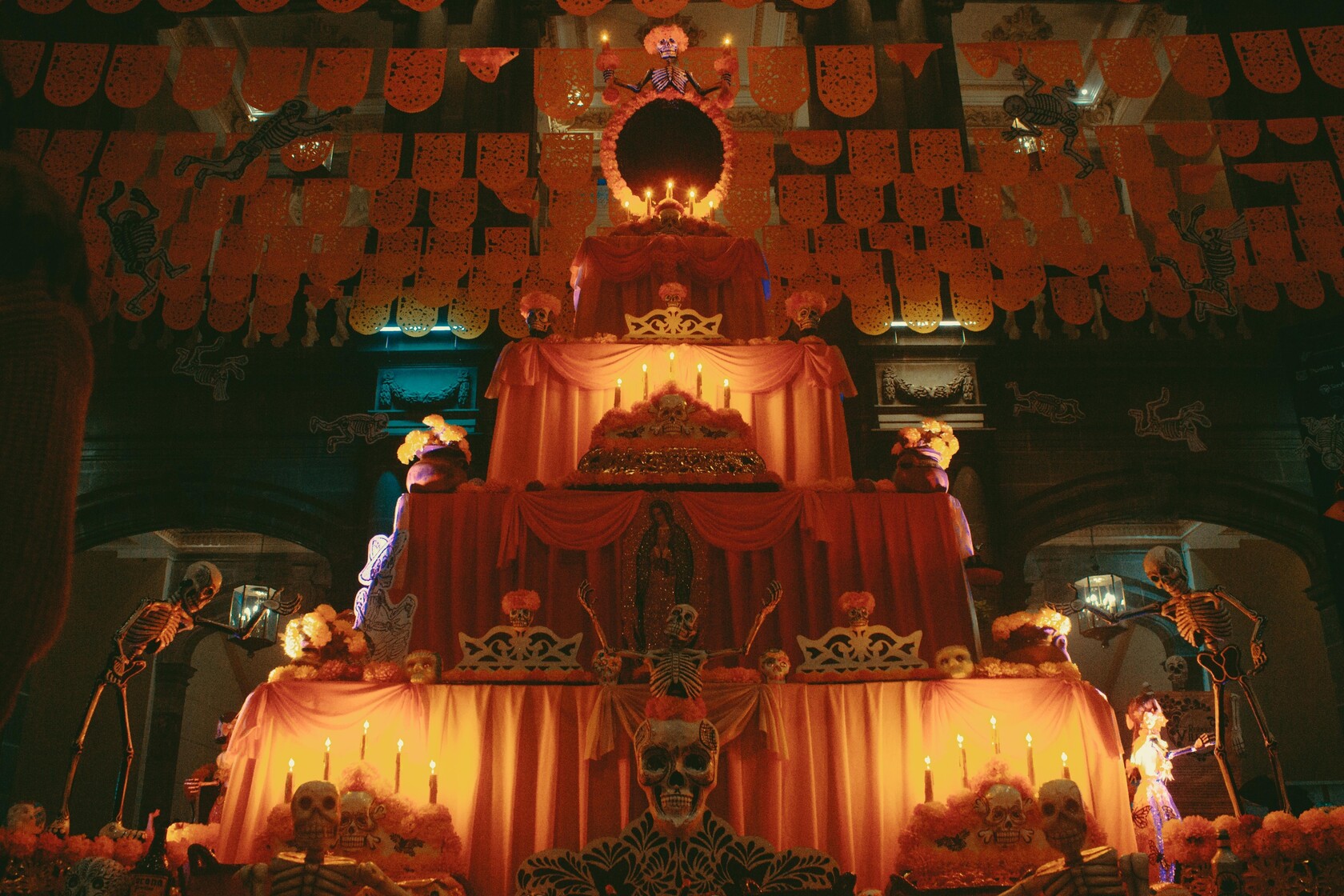 Colorful Día de los Muertos altar with candles and decorations in Puebla, Mexico.
